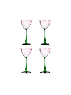 three pink and green wine glasses sitting next to each other