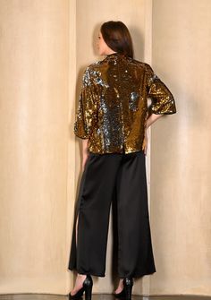 This is a unique button down Chinese collar jacket made entirely from a dual tone gold and silver sequin with contrasting black faux leather trims. For a formal evening or a night out, there is bling and then there is the Ava from Maneesha Ruia - simply stunning. Chic Embellished Outerwear For Party Season, Chic Sequined Outerwear For Evening, Glamorous Embellished Outerwear For Holiday, Chic Sequined Evening Outerwear, Glamorous Holiday Embellished Outerwear, Metallic Sequined Outerwear For Party, Embellished Outerwear For Party Season And Night Out, Metallic Sequined Party Outerwear, Metallic Sequin Party Outerwear