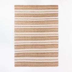 a brown and white striped rug on a white background