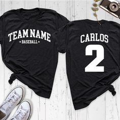 Baseball Team Shirt, Custom Name Number Shirt, Baseball Fan Mom Shirt, Baseball Lover Shirt, Personalized Game Day Shirt, Sports Dad Shirt Show your team spirit with our Baseball Team Shirt, perfect for passionate fans and players alike! Whether you're a proud mom or dad cheering from the stands, this Custom Name and Number Shirt adds a personal touch to your game day outfit. Our Baseball Mom Shirt and Sports Dad Shirt are ideal for supporting your favorite player, while the Baseball Lover Shirt Black Tops With Name Print For Team Events, Black Tops With Lettering For Sports Events, Casual Moisture-wicking Shirt For Team Events, Sporty Short Sleeve Top With Lettering, Sporty Cotton Shirt For Team Events, Team Spirit Tops With Letter Print For Sports Events, Team Spirit Top With Letter Print For Sports Events, Team Spirit T-shirt With Lettering, Sporty Tops With Lettering For Sports Season