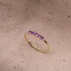 Our popular Candy Ring is gorgeous in a vintage style and set with Amethyst. The ring is 14k gold and has an stunning row of black stones decorated on the top face of the ring. It is delicate and dazzling while showing off some serious sparkle. This ring can be customized with any stones of your liking. Check out our size chart to find the perfect size for you! All features can be customized! Talk to us, we love making custom designs. Our jewelry is carefully handmade in our atelier Our diamonds Purple Gemstone Diamond Ring In 14k Gold, Purple Diamond Ring In 14k Gold, Classic Amethyst Round Band Ring, Timeless Gold Amethyst Ring For Anniversary, Classic Amethyst Diamond Ring In Yellow Gold, 14k Yellow Gold Stackable Amethyst Ring, Timeless 14k Gold Stackable Rings With Gemstones, Timeless 14k Gold Stackable Gemstone Rings, Fine Jewelry Amethyst Birthstone Ring With Round Band