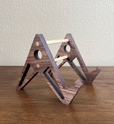 two wooden triangles are sitting on a table