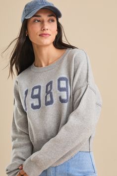 Relive the magic of an iconic album with this cozy 1989 pullover sweater. Perfect for any fan looking to add a touch of nostalgia to their wardrobe. Altar'd State, Oversized Sweatshirt, White Skirts, Pullover Sweater, Pullover Sweaters, Sweater Outfits, Heather Grey, The Magic, White Dress