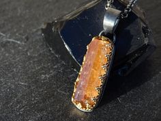 Raw Imperial Topaz crystal pendant, set in 14k gold and black sterling silver. Awesome as a single highlight or layered with other necklaces. Gorgeous gift for your 16th or 23rd wedding anniversary. Topaz is a December birthstone. > overall 33.5mm (1.31 inches) long Topaz pendant incl. the bail > 100% hand crafted from 14k yellow gold and sterling silver > genuine uncut Imperial Topaz gemstone crystal > black sterling silver necklace in the length of your choice The rough gemstone is an uncut, u Faceted Citrine Pendant Jewelry, Fusion Style Citrine Gold Jewelry, Minimalist Silver Citrine Jewelry, Minimalist Topaz Jewelry As A Gift, Unique Faceted Jewelry For Gifts, Hand Forged Rectangular Pendant Jewelry As Gift, Hand Forged Rectangular Pendant Jewelry For Gift, Topaz Pendant Jewelry As A Gift, Silver Faceted Citrine Necklace