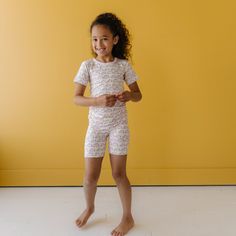 Image of little girl wearing a rainbow printed short sleeve and shorts pajama set. This print features multicolored rainbows that sit upon a white background with light pink accent trim. Pretty Swimwear, Pajamas All Day, Kids Pjs, There Is A Light, Accent Trim, Matching Shorts, Children's Boutique, Friend Outfits, Rainbow Print