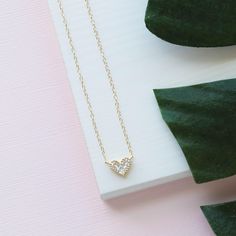 Our Gold Heart Necklace is so dainty & feminine! This cubic zirconia necklace sparkles just like a real diamond! It makes for the perfect gift to give a loved one as it is so simple and elegant. ---------------------- FEATURES ◊ Cubic Zirconia gold heart charm ◊ 14K gold filled chain ◊ All necklace findings (clasp, jump rings, tag) are 14K gold filled to ensure the highest quality piece ◊ Model is wearing the 17 inch length ---------------------- PACKAGING ◊ We do the gift-wrapping for you! Wedding Necklace With Heart Charm And Cubic Zirconia, Wedding Cubic Zirconia Necklace With Heart Charm, Wedding Heart Necklace With Diamond Accents For Valentine's Day, Valentine's Day Wedding Heart Necklace With Diamond Accents, Wedding Heart Necklace In Diamond White Cubic Zirconia, Cubic Zirconia Heart Necklace With Diamond Accents For Wedding, Diamond Heart Necklace For Wedding And Mother's Day, Delicate Heart Cut Necklace For Wedding, Heart Pendant Diamond Necklace With Delicate Chain For Anniversary