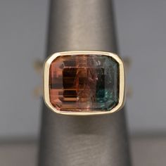 Handcrafted Bezel Set Watermelon Tourmaline Bold Statement Ring in 14k Yellow Gold This knockout of a ring is all about that gemmy stone!  The tourmaline is an emerald cut measuring 14.30mm x 12.07mm and 9.93mm in depth, weighing 13.08ct.  This juicy stone looks slightly more pink in person vs. the warmer color in the photos.  It's set in a thick bezel covering the sides and the shank is split at the base to provide stability for the ring.  It is also made in a Euro shank design.  The ring is cr Tourmaline Rings With Gemstone Accents, Fine Jewelry Tourmaline Gemstones, Bezel Ring, Gifts For My Wife, Watermelon Tourmaline, Bezel Setting, Emerald Cut, Statement Ring, Rings Statement