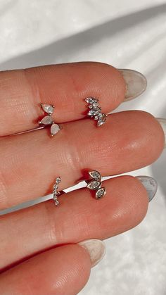 a woman's hand with three different rings on it