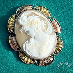 Early on in my antique jewelry career, another dealer gave me a bit of good advice about cameos, he said only to buy scenic cameos and cameos of Pretty Ladies. It's true, there's just something about a pretty lady, and this one is quite a classical beauty indeed! This wonderful Victorian cameo is set into a frame of 14 karat gold in an intricate combination of rose and green colored gold with beautifully engraved gold. This cameo was likely brought back from a Grand Tour of Europe, purchased mos Ornate Cameo Brooch, Ornate Cameo Brooches For Collectors, Victorian Style White Cameo Brooch, Victorian Style White Cameo Brooches, Classical Beauty, Victorian Cameo, Jewelry Holders, Black Hills Gold, Europe Tours