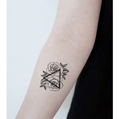 a woman's arm with a rose and triangle tattoo on the left inner arm