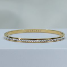 fire up a playful conversation on a sparkling night in our Enchanted Bangle Bracelet. double stack these babies for a luxurious vibe. a timeless staple that will be by your side for every special moment. channel set cz's add just the right amount of sparkle to light up the night. simply add a glass of champagne and you're ready for any celebration. 18kt gold or rhodium pvd over 316L stainless steel water resistant channel set cz's 4mm thick inside diameter is 2.5" pressure click closure sold ind Sparkling Night, Brazilian Gold, Synthetic Diamond, Light Up The Night, Glass Of Champagne, Gold Bond, Silver Bangle Bracelets, Channel Set, By Your Side