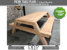 a wooden picnic table sitting next to a brick wall