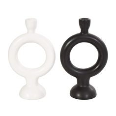 two black and white vases sitting next to each other