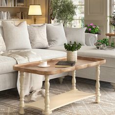 a living room filled with white furniture and lots of windows