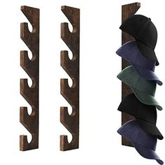 three hats are hanging on the wall next to two wooden racks with one hat in it