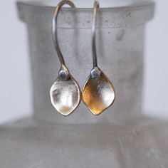 "Tiny gold petal dangle earrings. Each petal is handmade by melting 14k gold into a ball, and hammering and shaping it into a unique little buttercup petal shape. Because of the way I cupped the petals, they reflect light and glow like little buttercups in the sun. The Sterling Silver ear wires are hammered for durability. Polished to a brushed satin finish. These dainty little earrings are the perfect choice for every day, and can be dressed up or down for any occasion. Simple, elegant, comfort Hand-forged Drop Earrings For Gift, Hand Forged Drop Earrings For Gift, Hand Forged Drop Earrings For Wedding, Handmade Petal Shaped Elegant Earrings, Single Drop Earring In Recycled Gold, Delicate Teardrop Flower Earrings For Anniversary, Delicate Teardrop White Gold Earrings, Elegant Handmade Petal Earrings, Delicate White Gold Teardrop Earrings