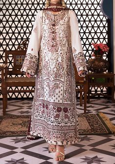 Introducing our New collection 'FASANA-E-ISHQ EID LUXURY LAWN COLLECTION' by Asim Jofa designed to make you look and feel your best. Embrace the serenade of petals with this ivory ensemble where maroon, sage green, and light pink threadwork weave a symphony of floral beauty accentuated by the golden shimmer of zari work and sequins. The floral motifs like whispers of spring dance against the maroon dupatta creating a melody of contrast and harmony. With embroidered panels and neckline, this ensemble becomes a garden of elegance. Embroidered sleeves with borders and a chaak border add to its allure while the chiffon dupatta with a four-sided border becomes a cascade of petals enveloping you in a timeless embrace of nature's grace. Embroidered Center Panel On Lawn. Embroidered Side Panels Ri Red Printed Lawn Suit For Wedding, Wedding Lawn Suit In Red With Printed Details, White Unstitched Maxi Dress, White Printed Dresses For Eid, White Dress With Printed Motifs For Eid, White Dresses With Printed Motifs For Eid, Red Long Sleeve Dress With Digital Print, Traditional Long Sleeve Dress With Digital Print, Bohemian White Dress With Digital Print