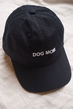 "DOG MOM" Intentionally Blank dad hat in black with white writting. One size. Adjustable back. Hand embroidered in LA. PIPE AND ROW Ftw Hat, Mom Hat, Intentionally Blank, Galentines Gifts, Stylish Caps, Mom Hats, Local Girls, Hat Ideas, Dog Mama