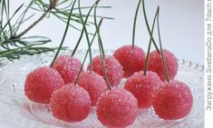 small cherries are sitting on a glass platter with pine needles in the background