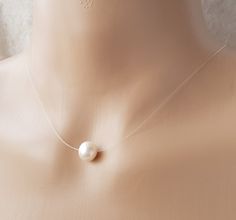 Genuine Cultured Freshwater Pearl Floating Illusion Necklace Stunning and simple will suit all occasions.  9-10mm very good lustre freshwater pearl on good quality jewellery illusion cord  finish with 14ct rose gold filled clasp. The pearls are genuine freshwater pearls therefore each pearl is slightly different in shape and size and each pearls has its own natural unique blemishes. Pretty organza gift bag included perfect for gifting All measurements mentioned in this listing is Approximately Clear Pearl Jewelry As A Gift, Pearl Jewelry For Gifts, Clear Pearl Jewelry For Gifts, Necklace Transparent, Double Strand Pearl Necklace, Illusion Necklace, Dainty Pearl Necklace, Black Freshwater Pearls, Backdrops Necklace