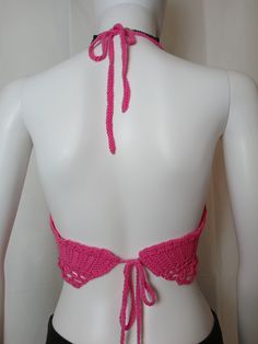 Hot Pink Rave & Festival Crochet Crop Halter with center lacing, adjustable neck ties and belly dancer style chain edging on bottom. The extra long bottom ties may be wrapped entirely around the rib cage & tied in front or left long and back tied.Made from 100% reclaimed cotton yarn1 of 1 Fitted Hippie Halter Top For Festival, Adjustable Bohemian Halter Top For Festivals, Pink Triangle Halter Top For Festivals, Fitted Bohemian Halter Top For Party, Festival Stretch Halter Top With Tie Back, Adjustable Triangle Halter Top For Festival, Stretch Halter Top With Tie Back For Festivals, Stretch Backless Halter Top For Festival, Bohemian Stretch Halter Top For Party