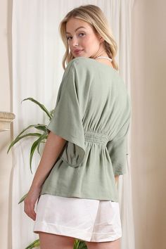 Lilou SS Deep V Neck Button Down Top Elevate your wardrobe with the Lilou SS Deep V Neck Button Down Top. This solid-colored blouse exudes elegance with its deep V neckline and kimono-style draped sleeves. Made from a comfortable cotton-linen blend in a sage color, it's perfect for any occasion. Functional buttons and a lined upper front ensure both beauty and practicality. Deep V Neckline Button Down Blouse with Draped Sleeves Pattern Type: Solid Color: Sage Neck Line: V-neck Sleeve Type: Kimon Kimono Blouse, Draped Sleeves, Athleisure Tops, Drape Sleeves, Sage Color, Kimono Sleeves, Kimono Sleeve, Button Down Blouse, V Neckline