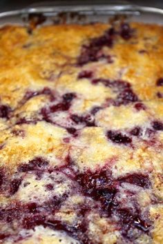 a close up of a casserole in a pan on a stove top with crumbs