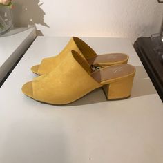 New York And Company Yellow Faux Suede Block Heel Slip On Mules Sandals Size 7. 2 1/2" Block Covered Heel. Man Made Materials. New With Tag. Smoke Free Home. Open To Reasonable Offers. Chic Slip-on Block Heels For Spring, Yellow Synthetic Mules With Round Toe, Spring Suede High Heel Block Heels, Yellow Open Toe Synthetic Mules, Spring Trendy Heels With Cushioned Footbed, Trendy Spring Heels With Cushioned Footbed, Casual Suede Sandals For Party, Trendy Cushioned Spring Heels, Yellow Casual Mules For Spring