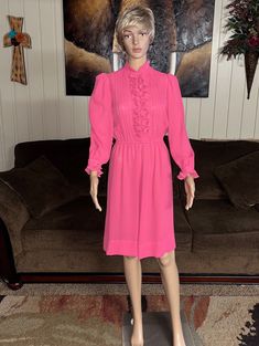 Vintage (1970's) Herman Marcus Dallas~ Size 6 Pink Dress. This is a beautiful pink dress with ruffle design. The dress is in MINT condition with NO tears or stains on the fabric!!  Details: 1.) Breast: 36" inches  2.) Shoulder to shoulder: 13" inches 3.) Sleeve Length: 28"inches 4.) Waist: 22-32" inches (elastic at waist to adjust) 5.) Hip: 40-46" inches 6.) Thigh: 40-46" inches (flare at bottom of dress) 7.) Shoulder to hem: 38" inches 8.) 4 buttons & snap for closure  9.) Fabric doesn't show, Pink Ruffle Dress, Ruffles Dress, Ruffle Design, Fabric Details, Vintage 1970s, Dress Clothes For Women, Ruffle Dress, Pink Dress, Mint Condition