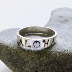 Hand Stamped Aloha Ring~ Send a gift of love, let your loved one know they are loved with this ALOHA ring. Custom made for you, each ring is hand forged with sterling silver and polished to a beautiful shine. Great gift for the sweetheart in your life! *This listing is for 1 hand stamped ALOHA ring made with sterling silver 4mm. X 1mm.* Each ring is a one of a kind and will vary. Shop~ http://www.etsy.com/shop/HanaMauiCreations?ref=si_shop International buyers please read our shipping policies b Surfer Girl Gifts, Hawaii Fashion, Aloha Friday, Tahitian Pearl Necklace, Crystal Point Necklace, Hawaii Style, Black Pearl Necklace, Hawaiian Jewelry, Rings Handmade