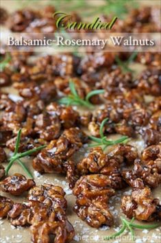 a close up of some food on a pan with rosemary sprigs in it