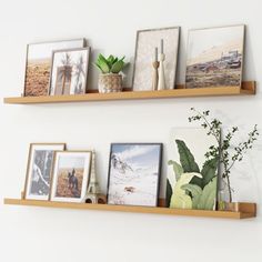 three wooden shelves with pictures and plants on them