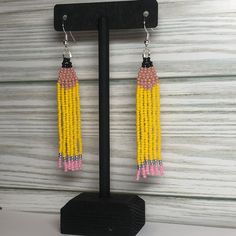 Hand beaded, one bead at a time. Made with glass beads and polyester thread. Fishhooks are silver plated and nickel free. Thread is reinforced with a metal thread guard to add to its lifespan. This pair is ready to ship and will arrive in a box, ready to be gifted to a loved one, or for yourself! All sales are final. Nickel Free Yellow Dangle Beaded Earrings, Nickel-free Yellow Dangle Beaded Earrings, Adjustable Multicolor Earrings With Silver Beads, Adjustable Yellow Beaded Earrings With Ear Wire, Adjustable Yellow Beaded Earrings, Adjustable Silver Beaded Earrings As Gift, Adjustable Silver Beaded Dangle Earrings, Adjustable Faceted Beaded Drop Earrings, Pencil Earrings