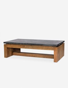 a wooden coffee table with black marble top