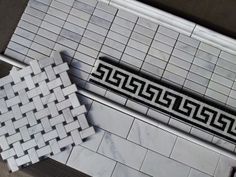 an aerial view of a bathroom with white and black tile