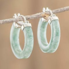 Guatemala's Jimenez Family crafts these stunning hoop earrings using jade obtained from the foothills of the Sierra de las Minas in Zacapa. Jade has long been associated with the concept of immortality as its hardness is close to that of a diamond. Here polished light green jade forms smooth hoops and are finished with sterling silver accents and saddleback catches. The artisans call the earrings Conexion which translates to connection in English. Light Green Earrings, Imperial Jade, Family Crafts, Green Earrings, Green Jade, Silver Accents, Jade Green, Silver Hoops, Ear Piercings