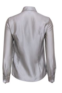 A classic style from a timeless fashion house, this Miu Miu button up is a wardrobe essential for every fashionista. Guaranteed to become your new go-to for luxe looks, this grey blouse features a metallic sheen, complimented perfectly by the black and white stripe print. Tuck it into a pencil skirt with pumps for a chic office look or keep it casual with a white tank and jeans. Size S 100% Silk Button front closure Buttoned cuffs Small blemish on front left at bottom Bust 34" Waist 31" Shoulder to hem 24" Sleeve length 23.5" Miu Miu Collared Workwear Tops, Miu Miu Collared Tops For Work, Miu Miu Collared Tops For Workwear, Miu Miu Classic Long Sleeve Tops, Classic Long Sleeve Miu Miu Tops, Miu Miu Tops For Spring Workwear, Casual Collared Tops By Miu Miu, Miu Miu Casual Tops For Workwear, Classic Gray Formal Tops