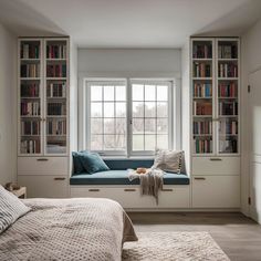 a bed sitting under a window next to a book shelf