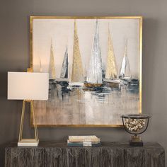 a painting is hanging on the wall next to a table with a lamp and vase