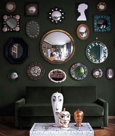 a living room filled with furniture and lots of mirrors on the wall above it's head