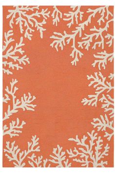 an orange rug with white snowflakes on it