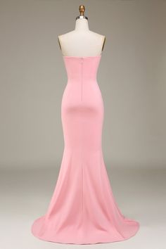 a pink dress on a mannequin with a white dummy behind it and the back of