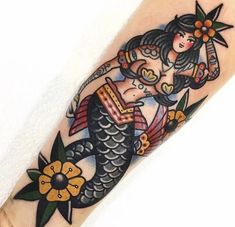 a woman is sitting on top of a fish with flowers in her hair and holding an umbrella