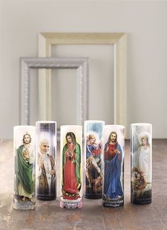 five candles with images of the virgin mary and jesus