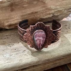 I Designed And Hand Crafted This Genuine Copper And Rhodonite Cuff Bracelet. The Copper Surrounding The Rhodonite Is Hand Hammered. The Inside Of The Cuff Is Stamped With My Maker's Mark. Truly A Unique Design, Slightly Oxidized To Help The Stampings And Hammerings To Shine Through. The Cuff Measures 6 X 3/4 Inches. The Piece With The Stone Measures 1.5 X 1.5 Inches. This Piece Comes Gift Boxed And Also Includes My Studios Business Card With My Contact Information. Adjustable Pink Bohemian Cuff Bracelet, Bohemian Adjustable Pink Cuff Bracelet, Pink Bohemian Adjustable Cuff Bracelet, Unique Adjustable Pink Cuff Bracelet, Artisan Pink Gemstone Jewelry, Pink Hand-wrapped Bangle Jewelry, Hand Wrapped Pink Bangle Jewelry, Pink Hand Wrapped Bangle Jewelry, Bohemian Pink Cuff Bracelet As Gift