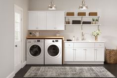 a washer and dryer sitting in a room next to each other on top of a rug