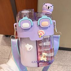 a purple and blue purse with teddy bears on the front, attached to it's strap