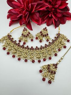 This is a beautiful Polki/Reverse AD Mehndi polish Maroon/Dark red Semi-bridal necklace set with matching long earrings and Tika has amazing shine. This is so beautiful to look at and a perfect one for Indian weddings.  Color : gold, Maroon/Red Necklace length : collar necklace length Necklace width :  Earring length : 2.5 inch Earring width : 1.75 inch Each Earring Weight: 12.8 Grams Material : Brass, Reverse AD, pearls Beautiful High Quality, premium jewelry. Free US standard shipping. Hand cr Bollywood Style Intricate Design Gift Sets, Bollywood Style Gift Sets With Intricate Design, Chandbali Tilla Bridal Sets As Gift, Tilla Chandbali Bridal Set Gift, Festive Bridal Sets With Tilla Detail As Gift, Festive Bridal Sets With Tilla As A Gift, Chandbali Jewelry Sets For Eid Gift, Kundan Bridal Sets For Eid Gift, Eid Kundan Jewelry Sets As Gift