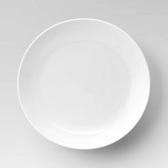 an empty white plate on a gray background