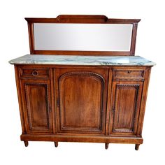 a wooden cabinet with marble top and mirror